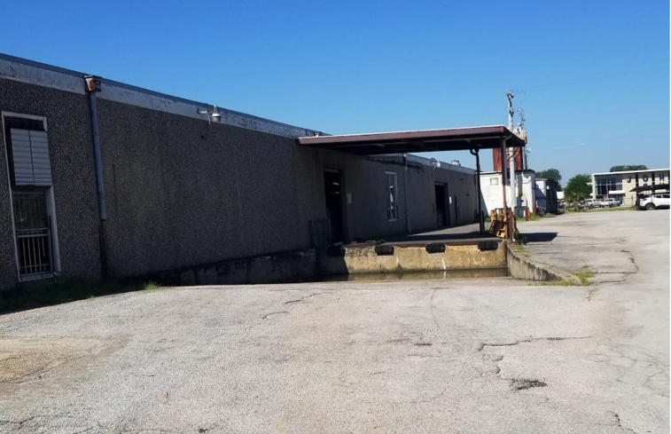 front view image of side loading truck well added to a grade level warehouse facility | Warehouse Finder