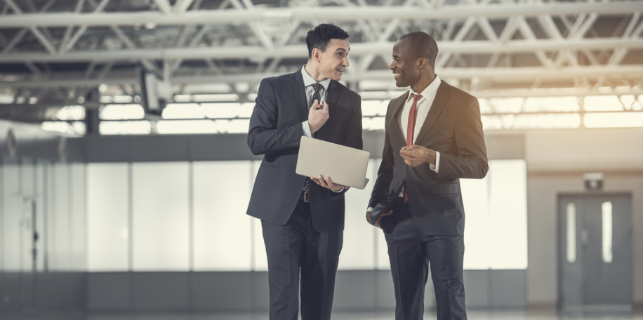 Two Guys Talking Real Estate in a Warehouse