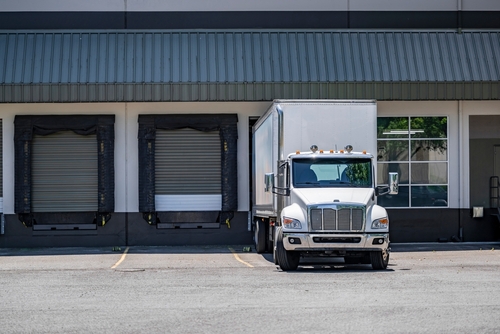 Photo Illustration of Dock High building with Semi-Truck and Trailer | Warehouse Finder